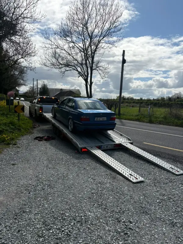 Car being loaded onto the Healy vehicle transporter at the roadside