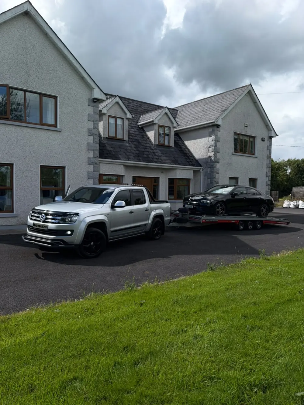 Healy pickup and transporter carrying a black car