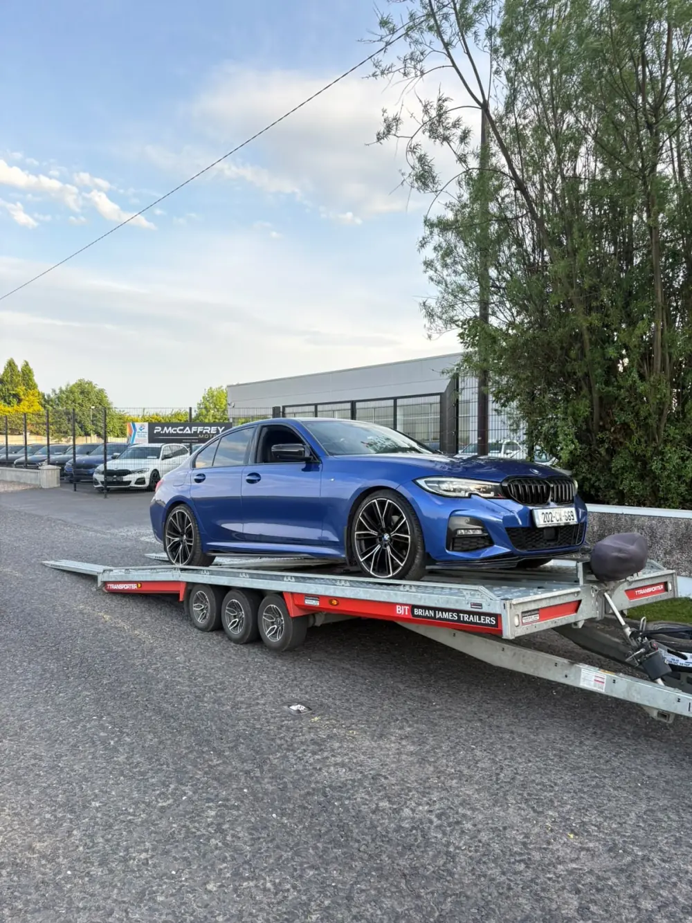 Blue car secured on the Healy vehicle transporter