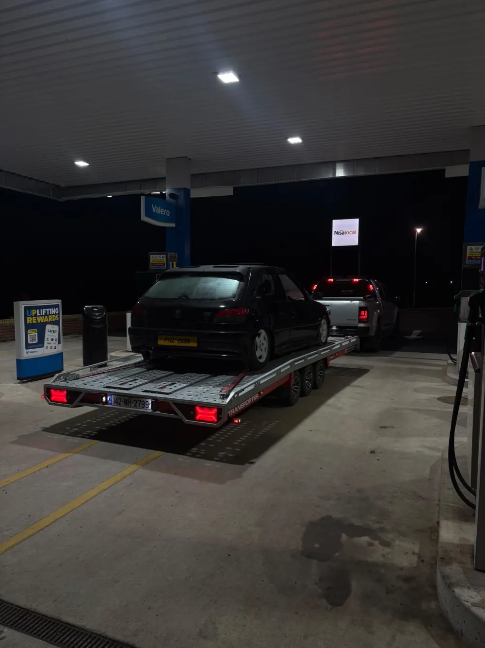 Car secured to the Healy transporter during a night collection