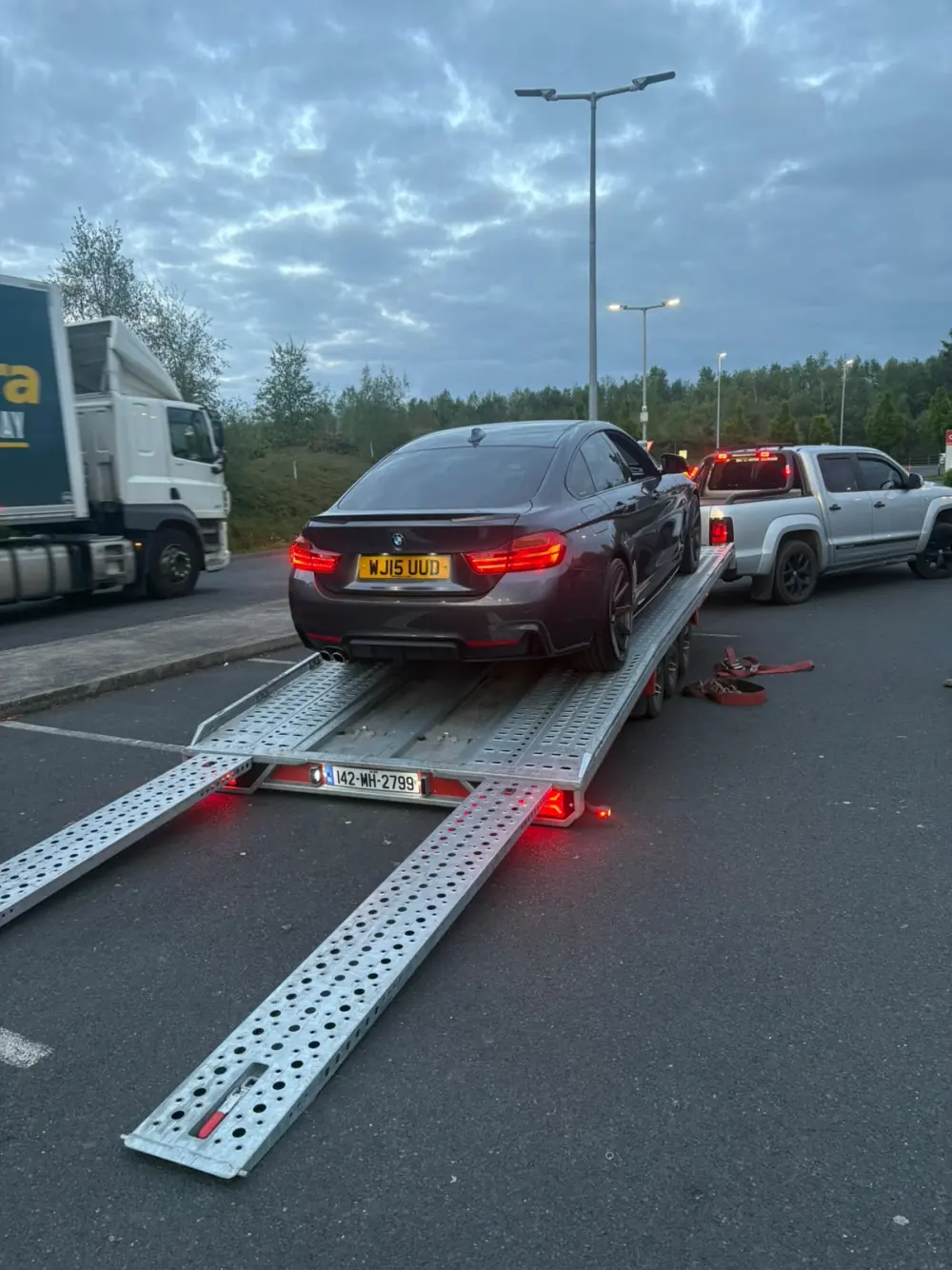 Car being loaded onto the Healy transporter during an evening collection